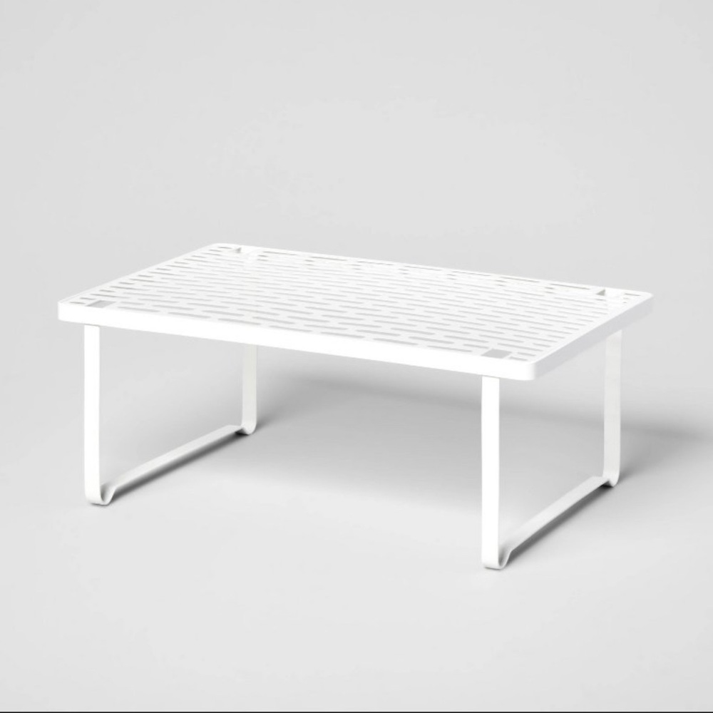 Punched metal shelf for additional storage